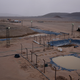 A chemical processing facility near the west bank of the Nile River, 40km south of Wawa, Sudan. Here, cynaide pools work to separate gold from the rock powder. The processing facility operators work in shifts, with the generators running 24 hours a day.